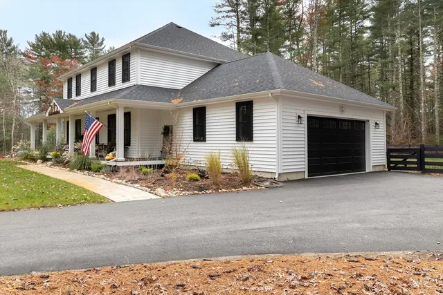an aerial view of residential house with outdoor space and trees all around