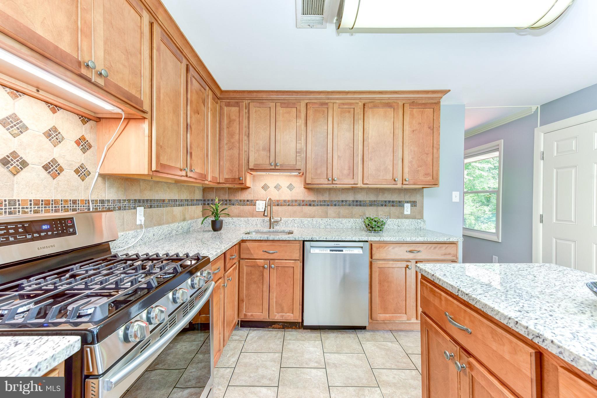 7201 Fort Hunt Road Alexandria, VA 22307 - Photo 2 of 30 a kitchen with stainless steel appliances granite countertop a stove a sink and a microwave