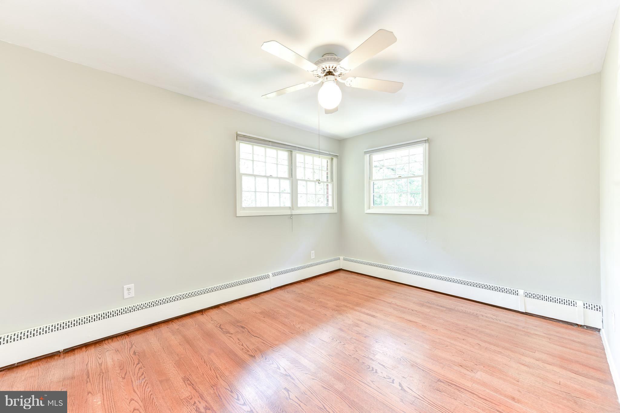 7201 Fort Hunt Road Alexandria, VA 22307 - Photo 12 of 30 wooden floor in an empty room with a window