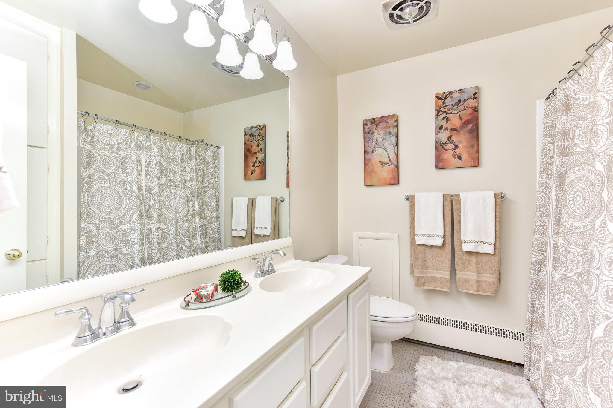 7201 Fort Hunt Road Alexandria, VA 22307 - Photo 14 of 30 a bathroom with a sink a toilet and a large mirror