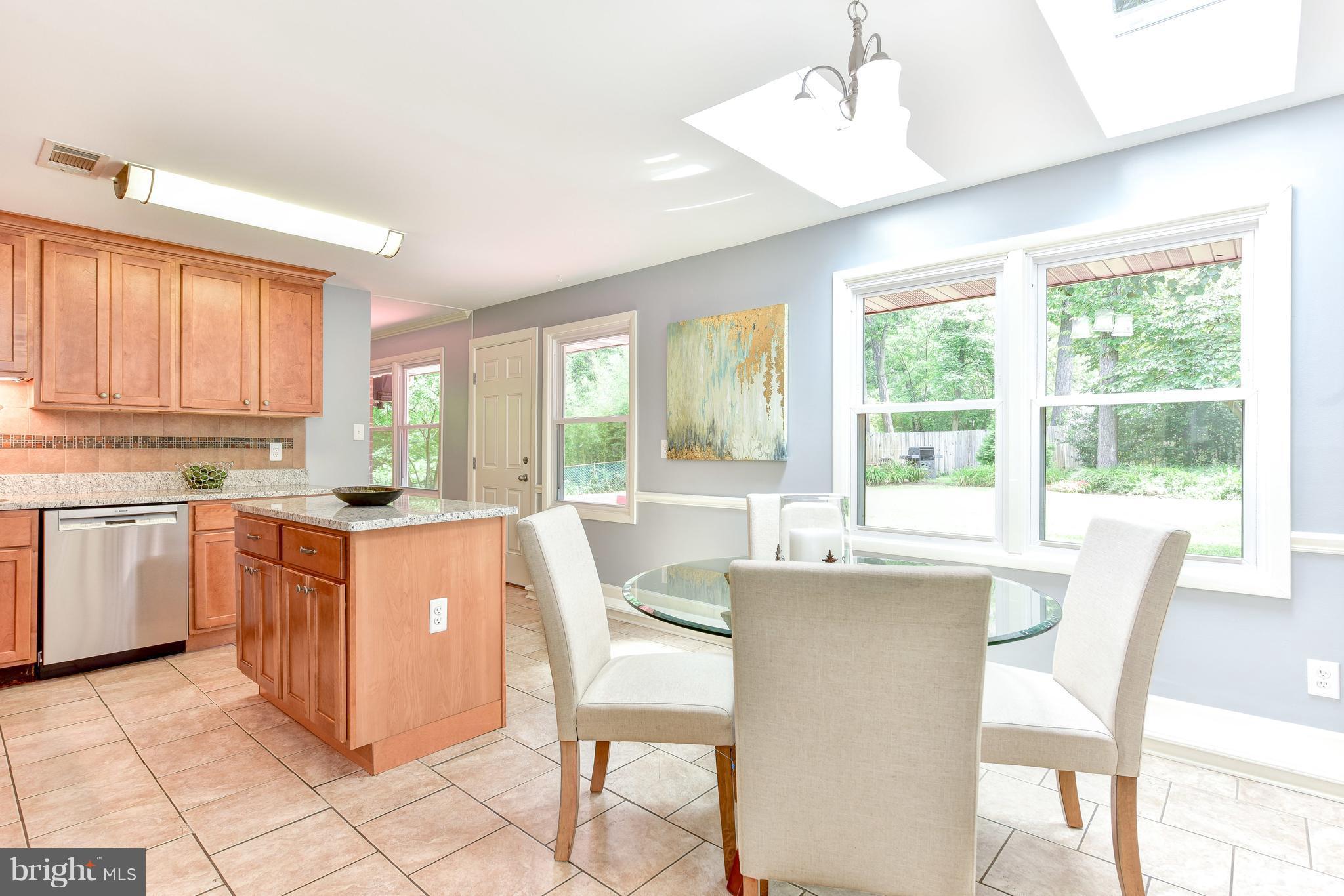 7201 Fort Hunt Road Alexandria, VA 22307 - Photo 3 of 30 a kitchen with stainless steel appliances granite countertop white cabinets and window