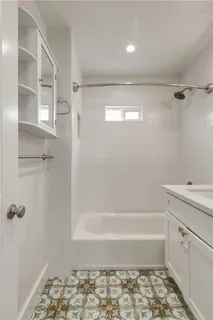 a bathroom with a bathtub and a shower