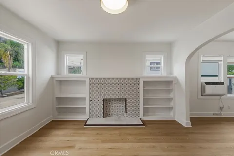 a living room with a fireplace and a window