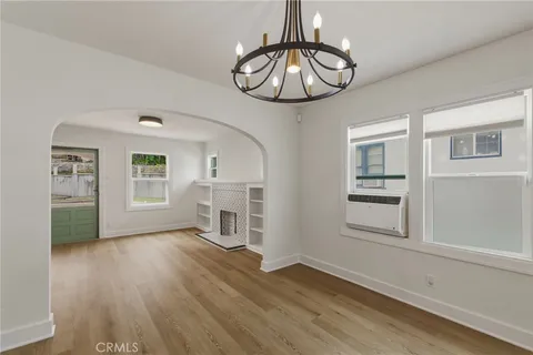 a view of livingroom with furniture wooden floor chandelier