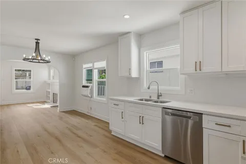 a kitchen with a sink cabinets and window
