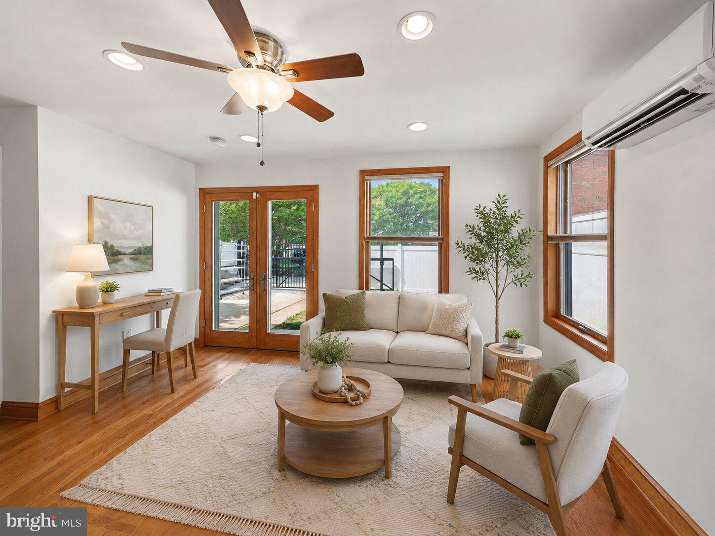 4504 20th Street Northeast Washington, DC 20018 - Photo 19 of 48 a living room with furniture a ceiling fan and a large window
