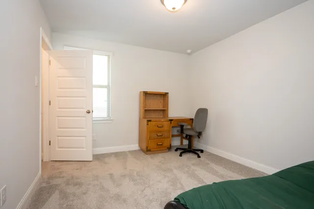 an empty room with windows and cabinet