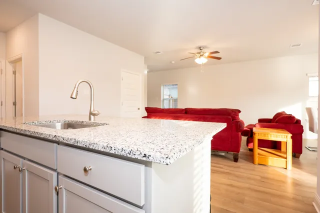 a en suite bathroom with a granite countertop double vanity and a sink