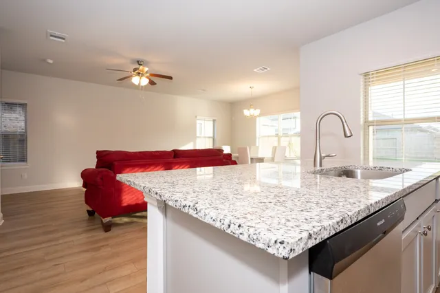 a view of kitchen island with granite countertop living room
