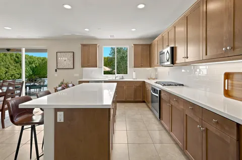 a kitchen with stainless steel appliances granite countertop a sink and a counter top space