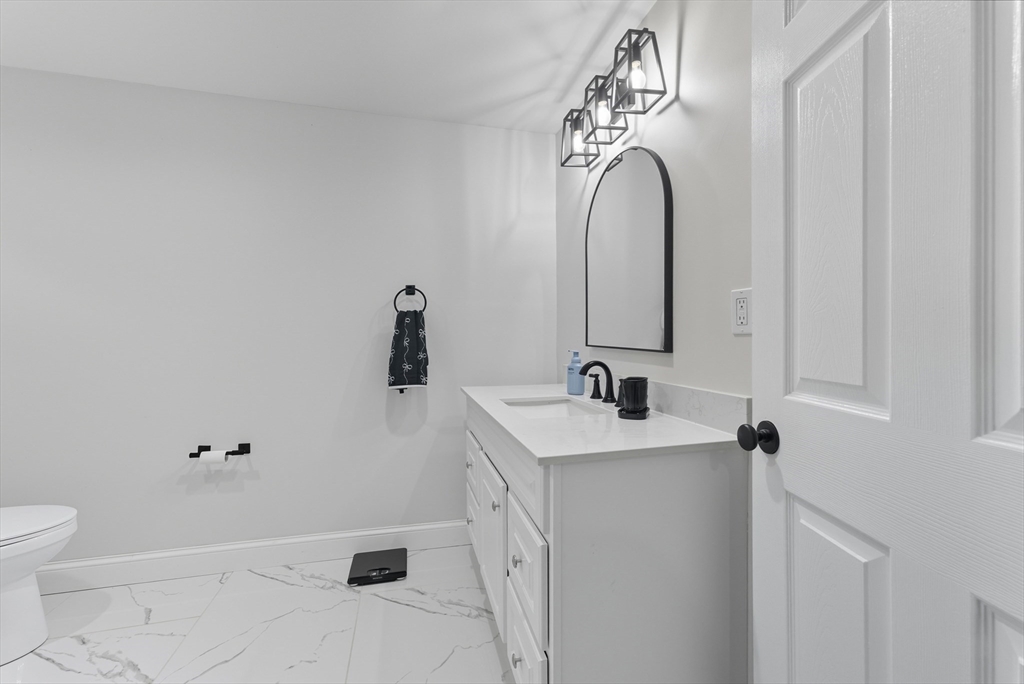 24 Elm Street Ludlow, MA 01056 - Photo 13 of 39 a bathroom with a sink and a mirror