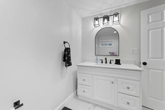 a white toilet sitting next to a bathroom sink