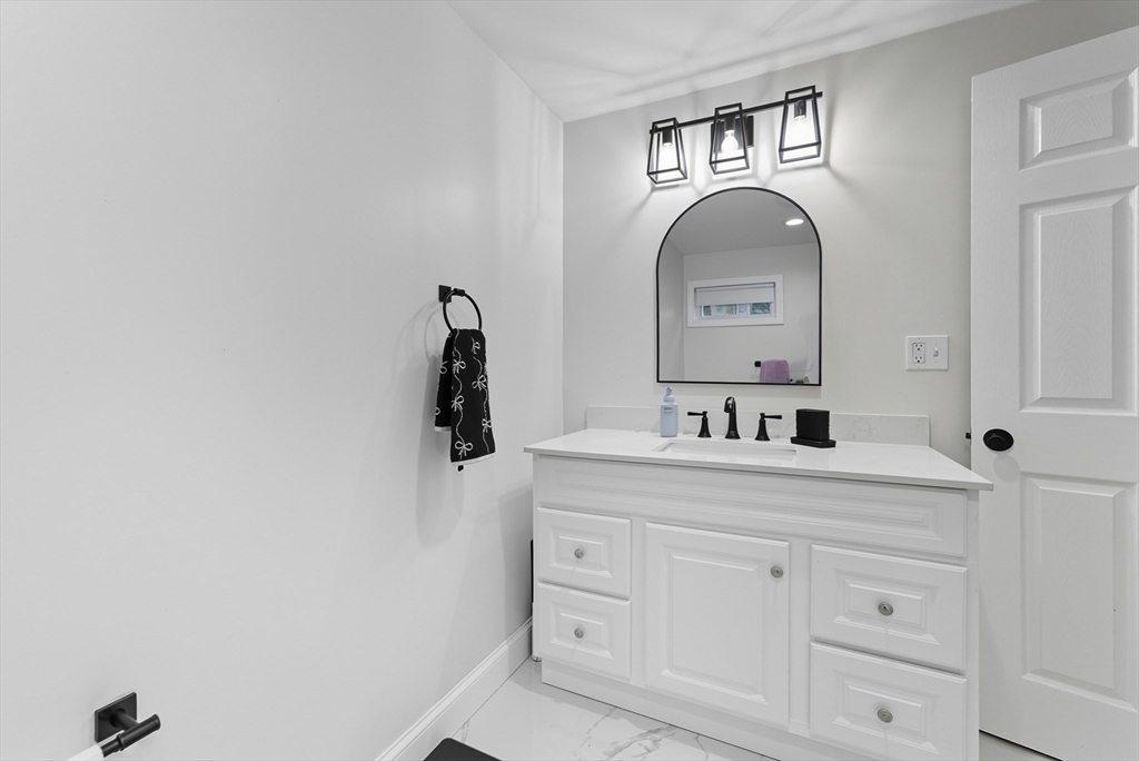 24 Elm Street Ludlow, MA 01056 - Photo 14 of 39 a bathroom with a sink and a mirror