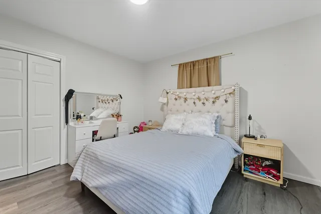 a bedroom with a bed and a dresser in it