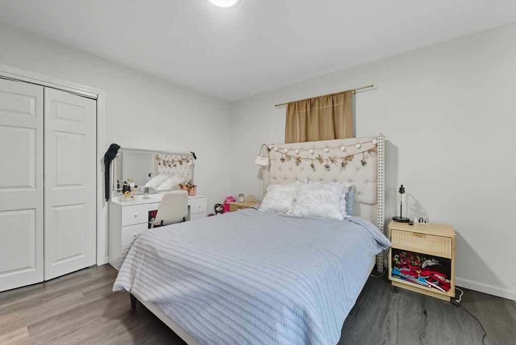 24 Elm Street Ludlow, MA 01056 - Photo 19 of 39 a bedroom with a bed and wooden floor