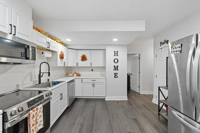 a kitchen with refrigerator and cabinets