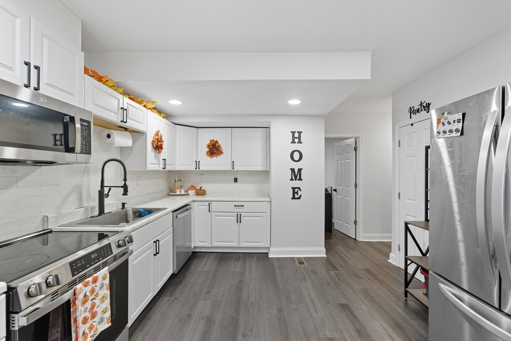24 Elm Street Ludlow, MA 01056 - Photo 2 of 39 a kitchen with refrigerator and cabinets