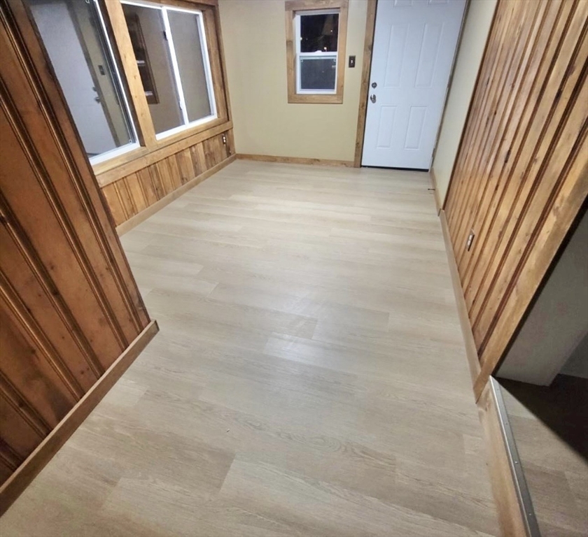 24 Elm Street Ludlow, MA 01056 - Photo 25 of 39 a view of an empty room with wooden floor and stairs