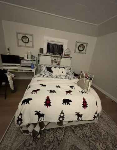 a view of a room with water heater and wooden floor