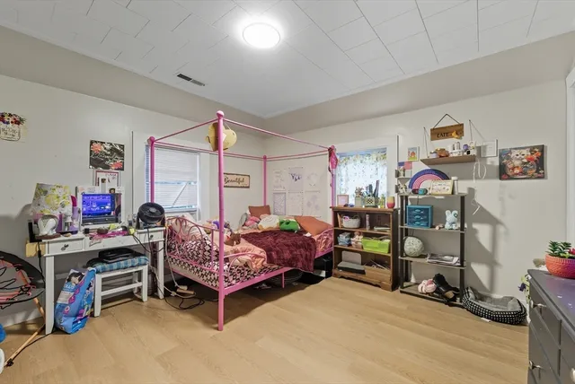 a bed room with a bed and a flat screen tv