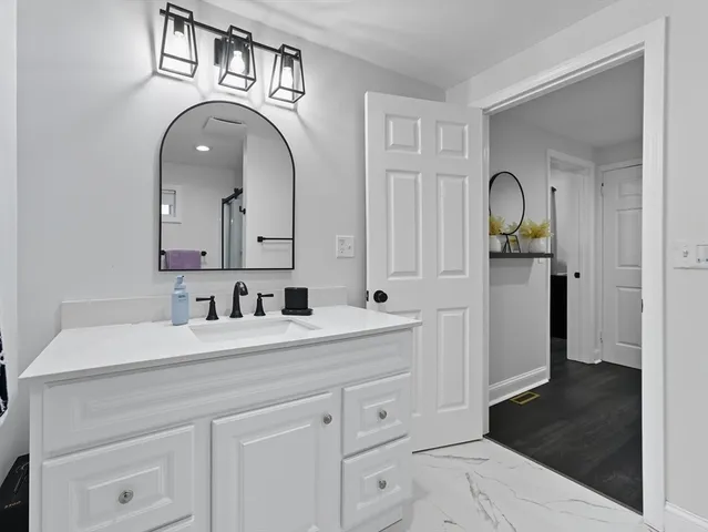 a kitchen with white cabinets and white appliances