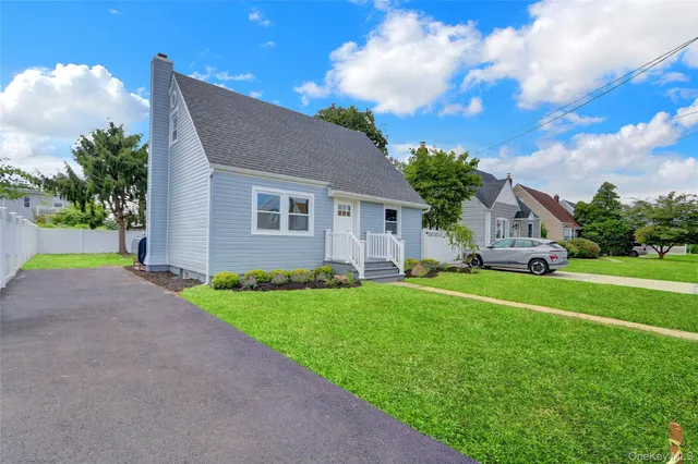 a front view of house with yard and green space