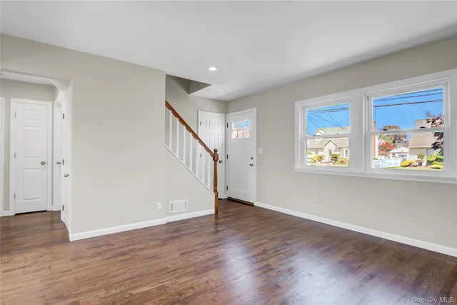 a view of an entryway with wooden floor