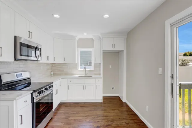 a kitchen with stainless steel appliances granite countertop a stove and a sink