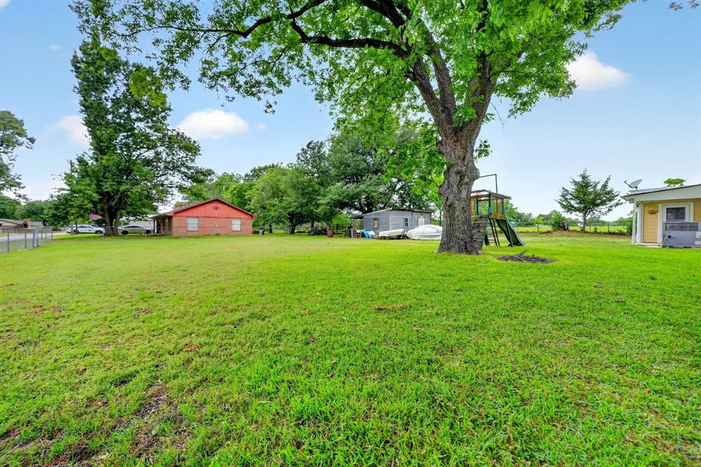 610 Crooked Creek Road Edgewood, TX 75117 - Photo 28 of 33 a view of a garden with a bench