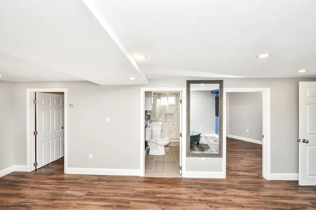 a view of a big room with wooden floor and windows