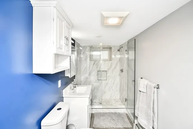 a bathroom with a sink toilet and shower