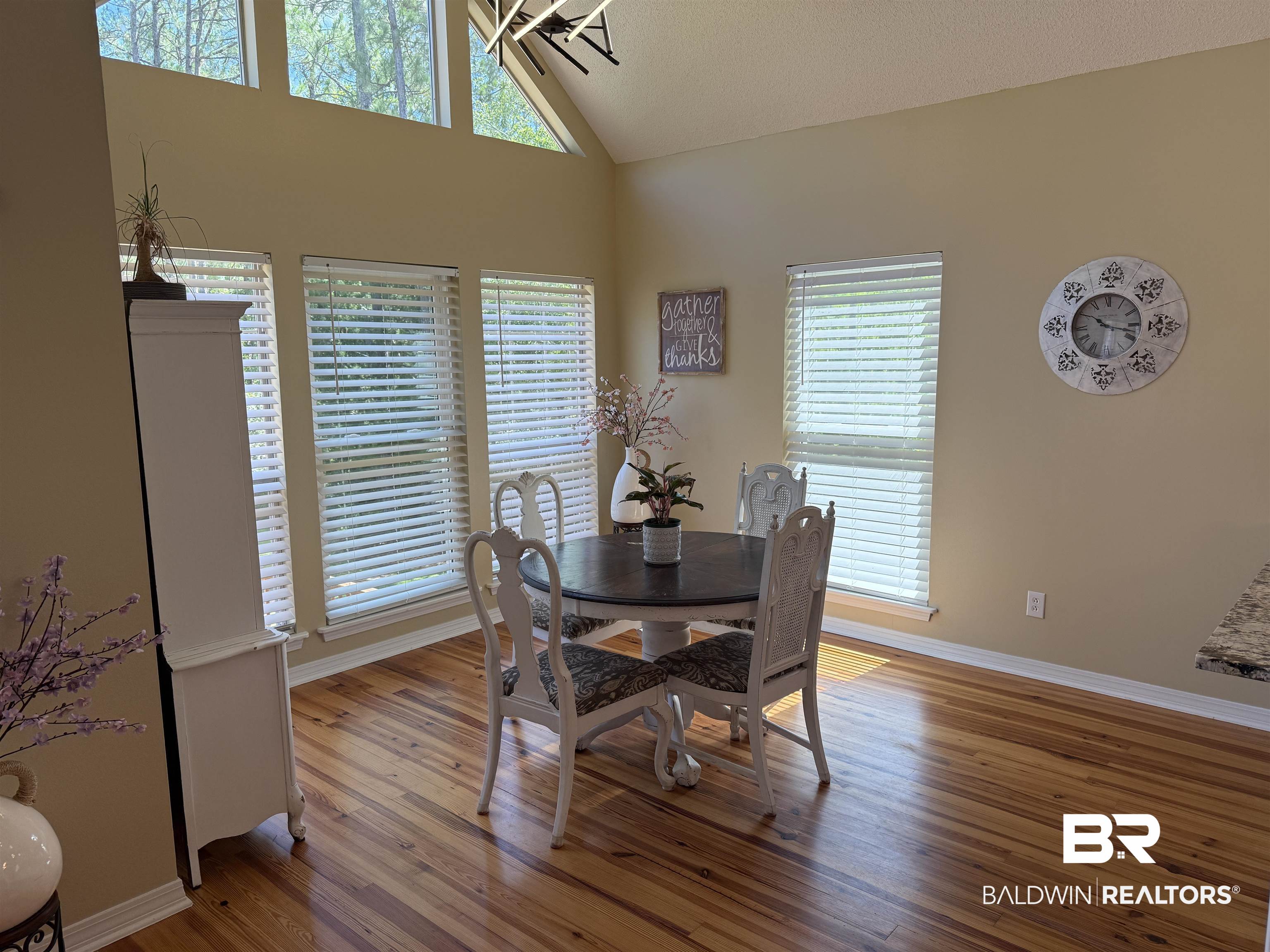 14601 Trawick Road Stapleton, AL 36578 - Photo 6 of 37 Dining room featuring wood finished floors, high vaulted ceiling, and a chandelier