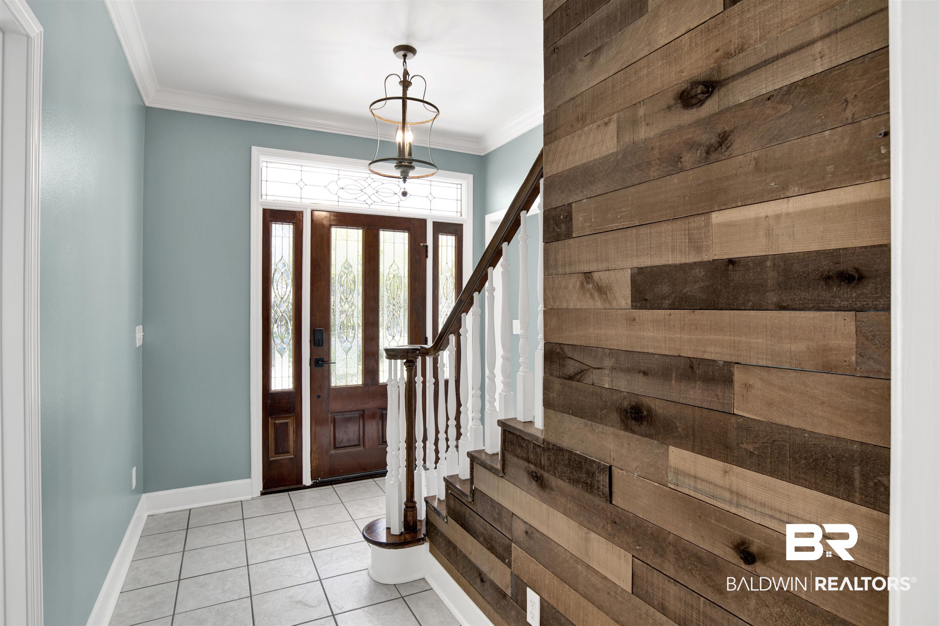 11835 Island Drive Foley, AL 36535 - Photo 23 of 53 Foyer entrance with ornamental molding, tile patterned floors, and stairs