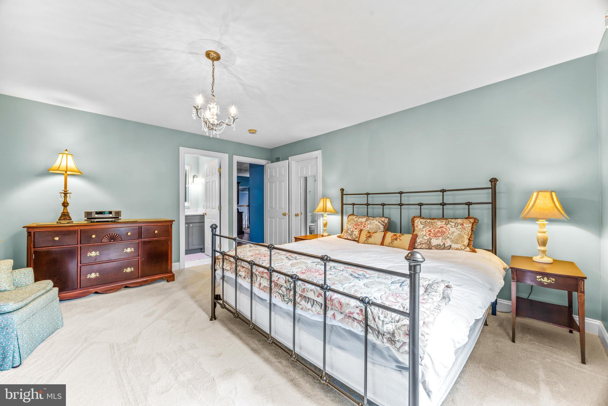 1402 Magers Landing Road Monkton, MD 21111 - Photo 37 of 64 a bedroom with a bed and a chandelier