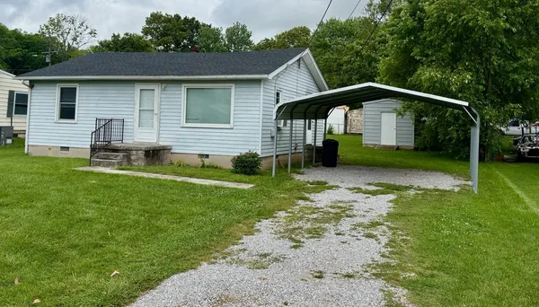 a front view of a house with a yard and porch
