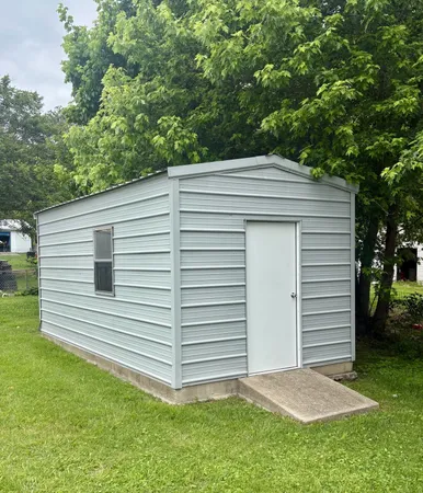 a view of a white house next to a yard