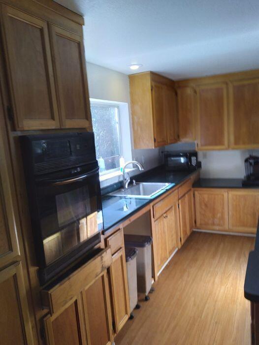 14966 Phillips Road Oak Run, CA 96069 - Photo 3 of 5 a kitchen with granite countertop a sink stove and cabinets