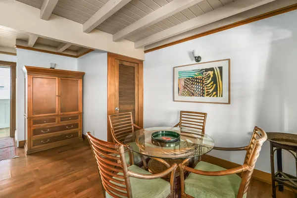 a view of a dining room with furniture wooden floor and a rug
