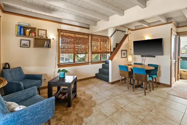 a living room with furniture a window and a flat screen tv