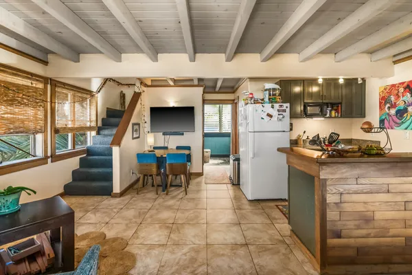 a kitchen with furniture a counter top space and stainless steel appliances