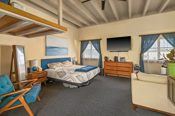 a bedroom with bed and window