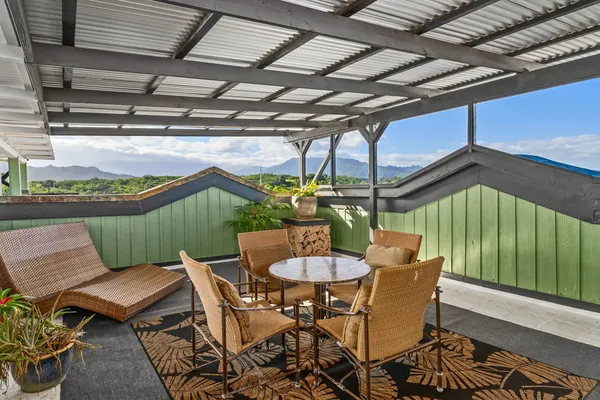 a view of a chairs and table in patio