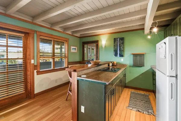 a kitchen that has a sink a refrigerator and a stove