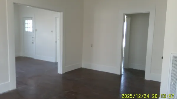 an empty room with wooden floor