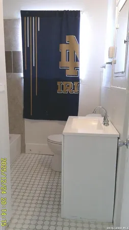 a bathroom with a sink a toilet and mirror