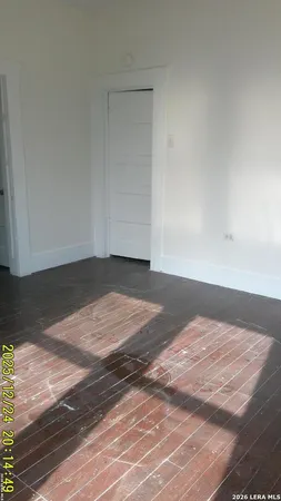 a view of a room with wooden floor