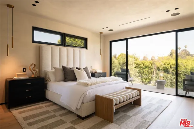 a bedroom with a large bed and a large window