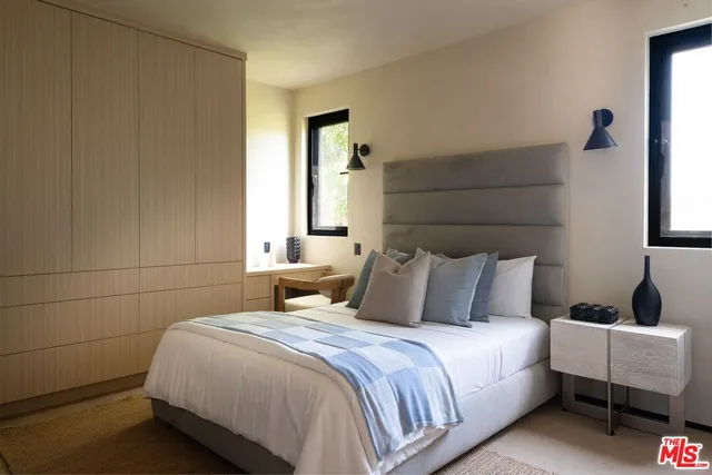 a bedroom with a bed and a lamp