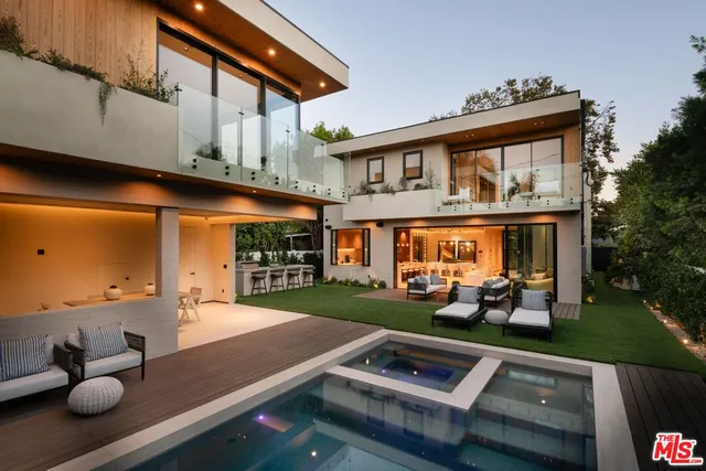 a view of a house with backyard porch and sitting area