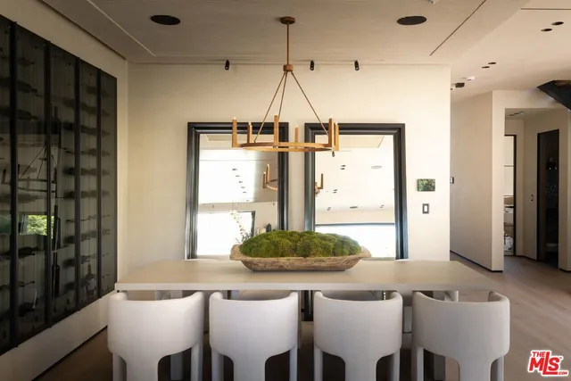 a dining room with a table chairs and a chandelier
